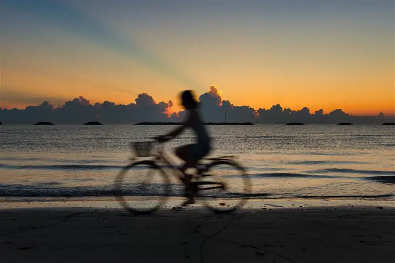 woman-by-bicycle-at-the-beach-at-dawn-2025-03-08-19-17-34-utc